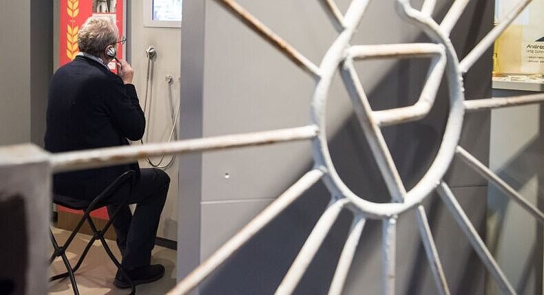 A man sits in a stool in the permanent exhibition