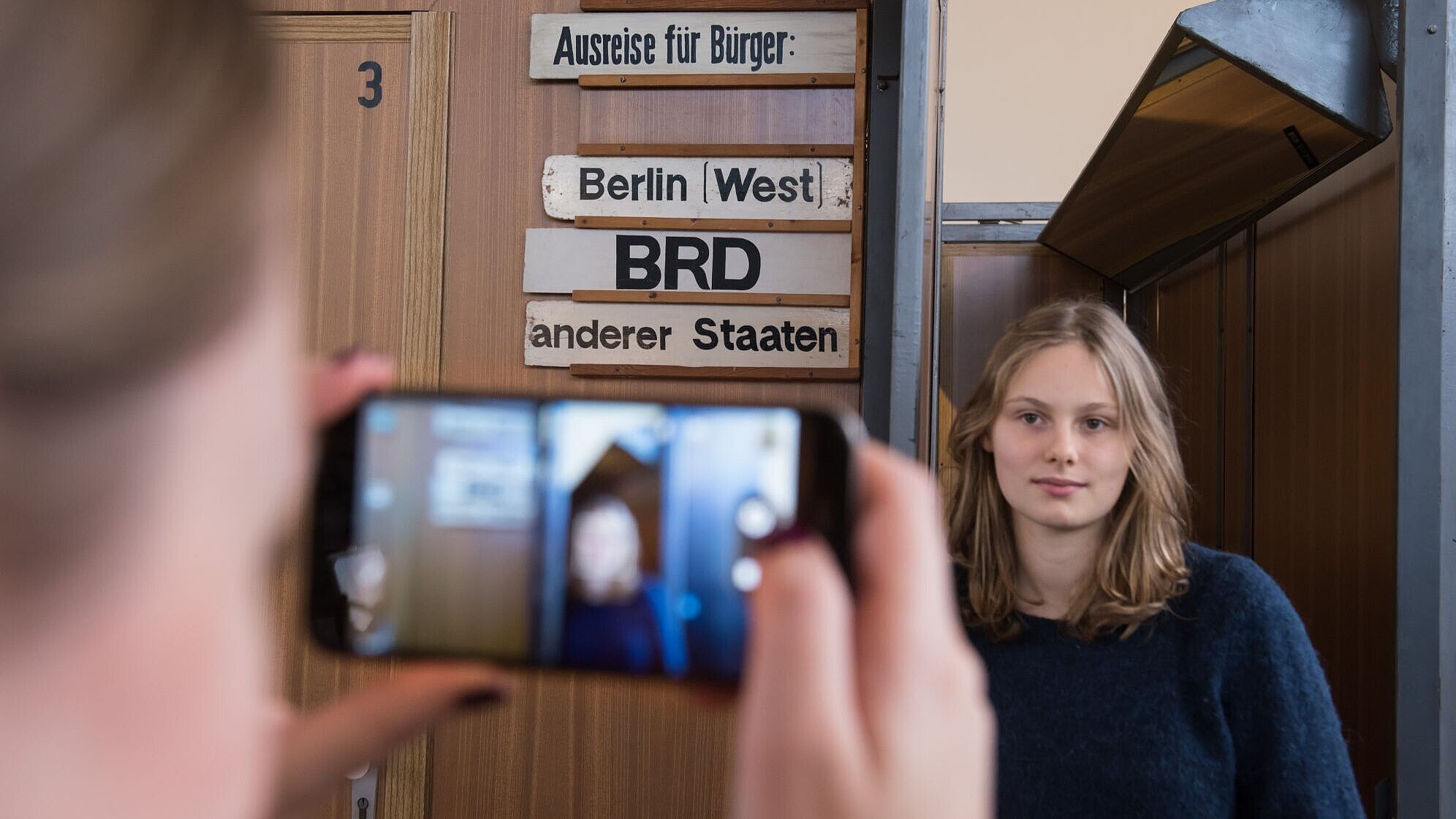 A visitor is taking a picture of a young girl in our exhibition