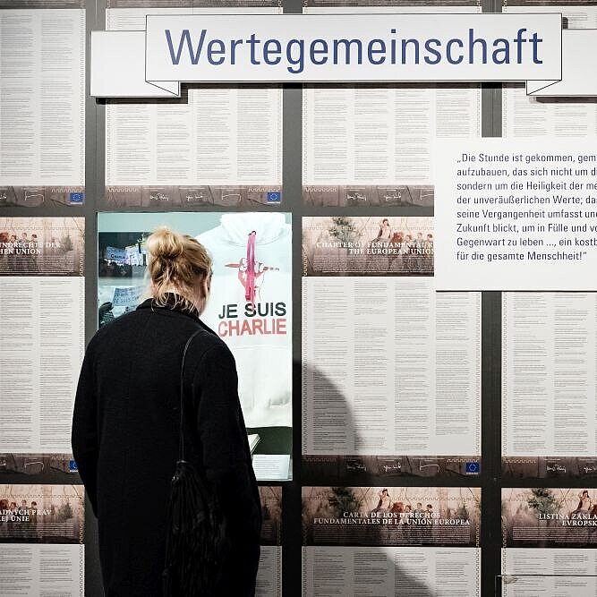 Visitor in front of a wall with the Charter of Fundamental Rights of the European Union