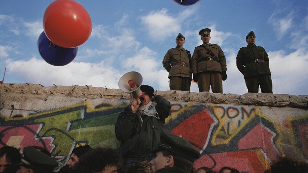 Balloons and border guards at the Berlin Wall.