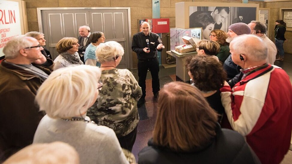 A group of elderly people is attending a guided visit