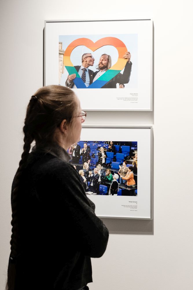 A visitor looks at photos with the topic same-sex marriage