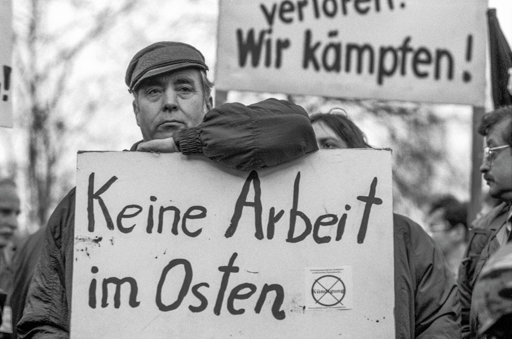 Man with poster "No work in the east"