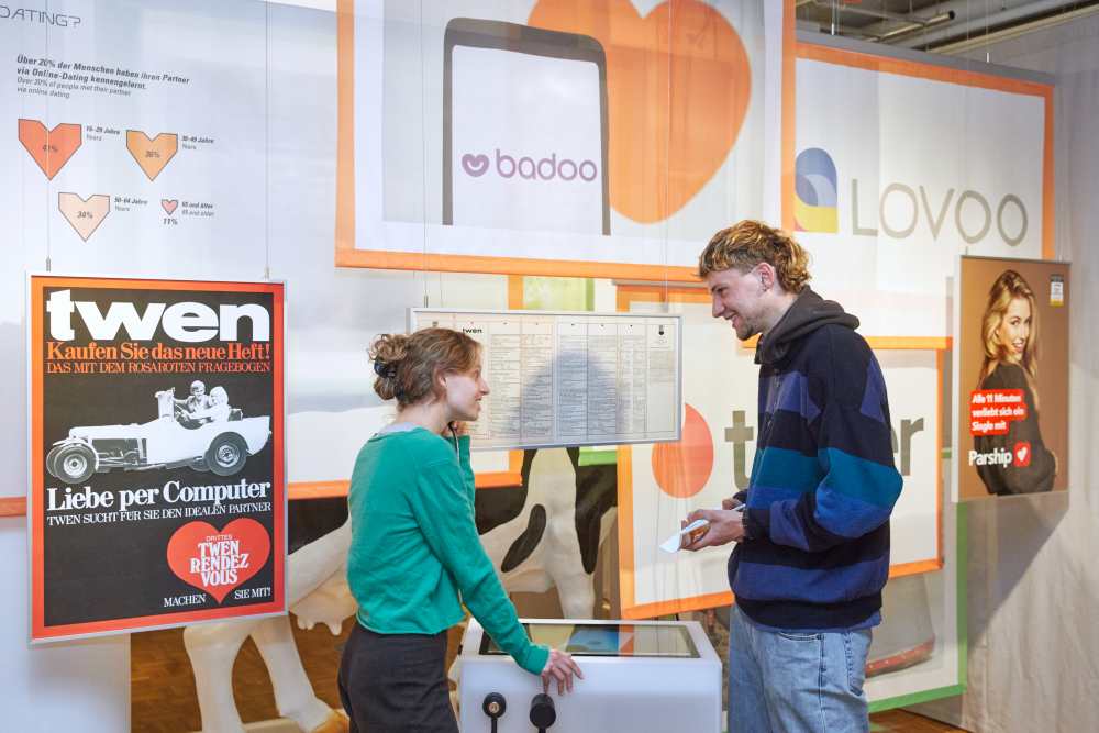Visitors explore the exhibition area on online dating