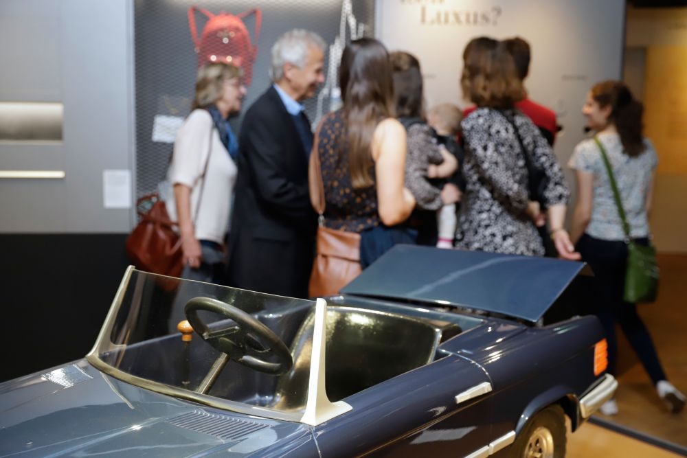 Childrens Mercedes and visitors in the exhibition