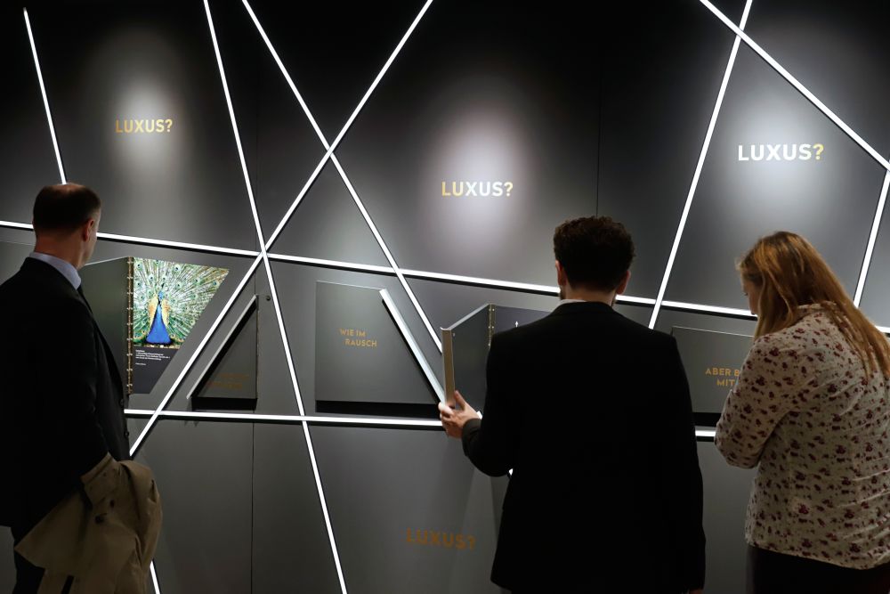 Visitors in front of a wall installation in the exhibition