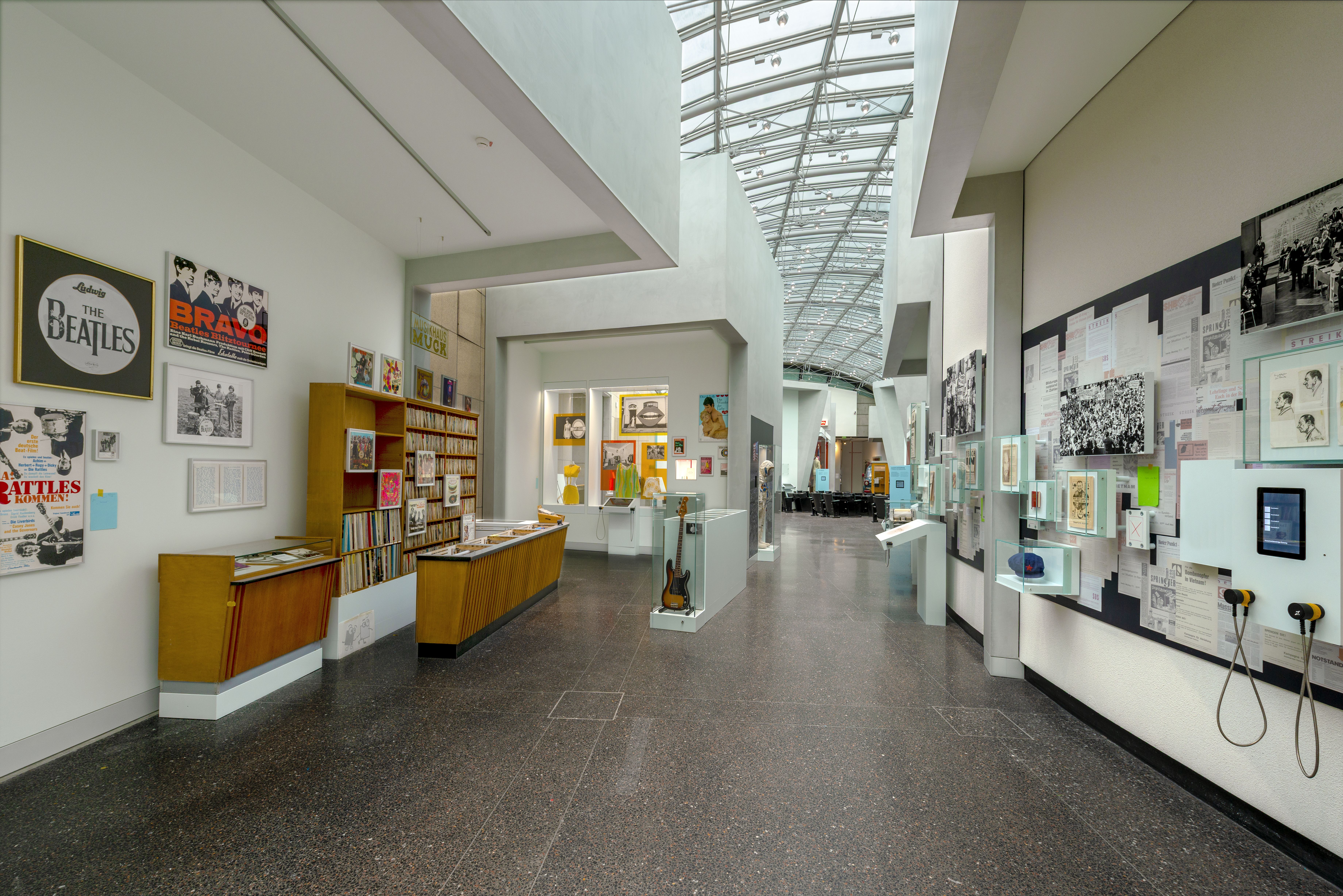 Ausstellungsansicht mit einer Plattenbar an der linken Seite