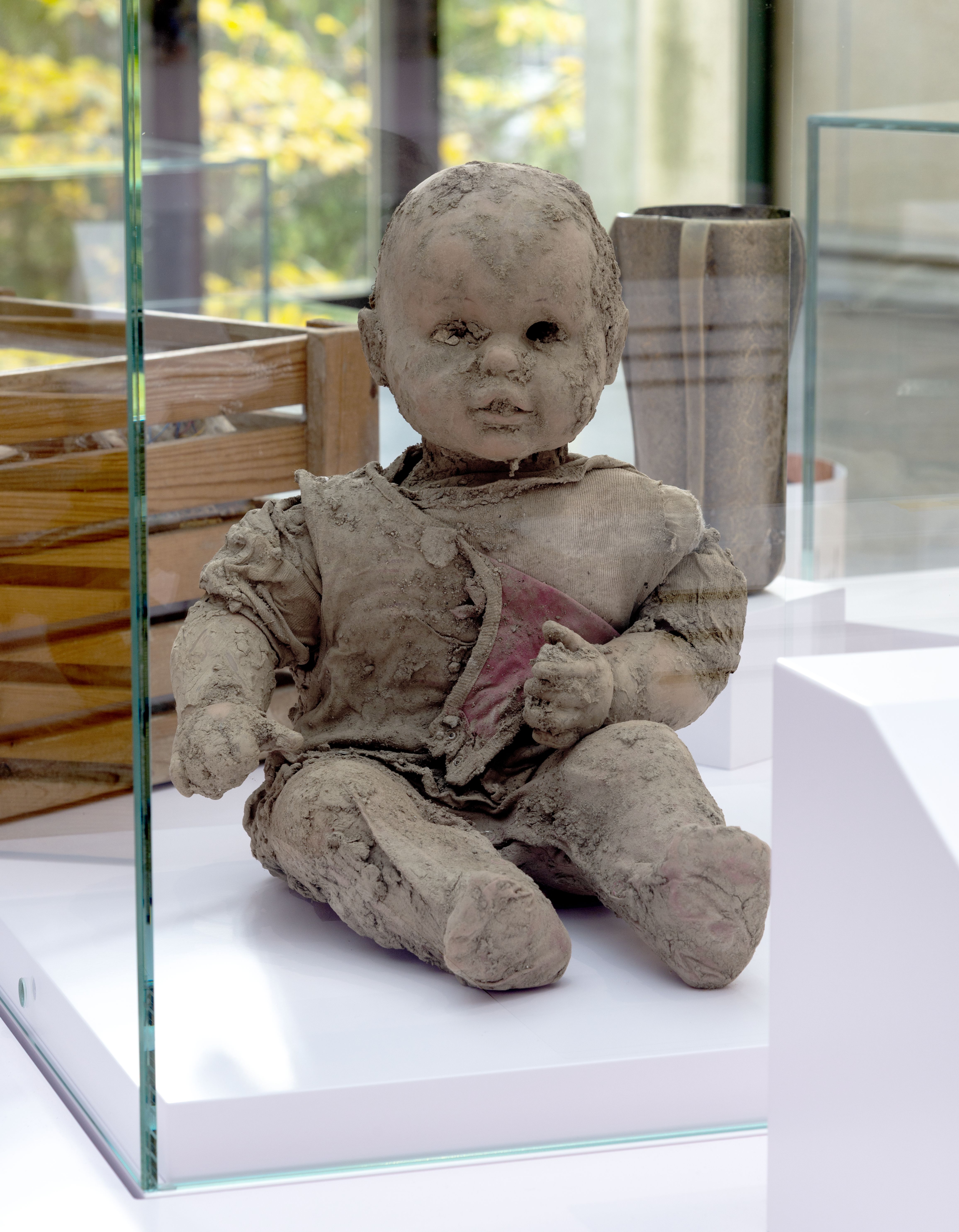 Eine Puppe voll Schlamm aus dem Ahrtal in der Ausstellung im Haus der Geschichte