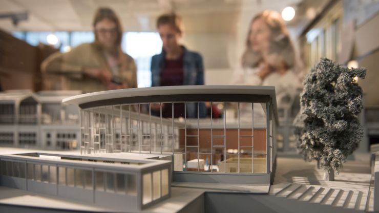 Foto: Im Vordergrund ein Modell des Tränenpalasts, im Hintergrund Besuchende der Ausstellung.