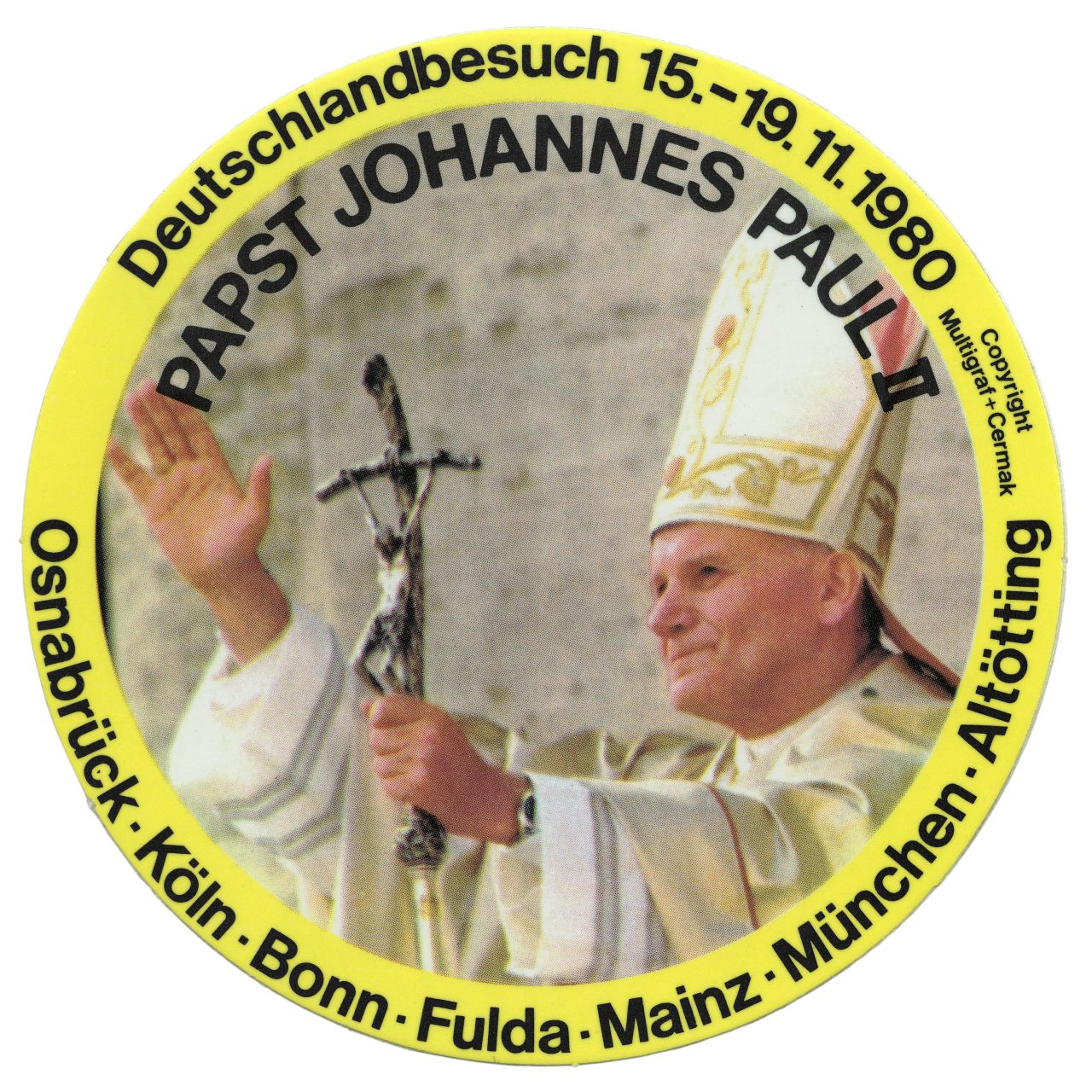 Farbige Abbildung des Papstes mit erhobener rechter Hand. Mit der anderen Hand hält er einen Stab mit einem Kreuz. Oben schwarzer Schriftzug.