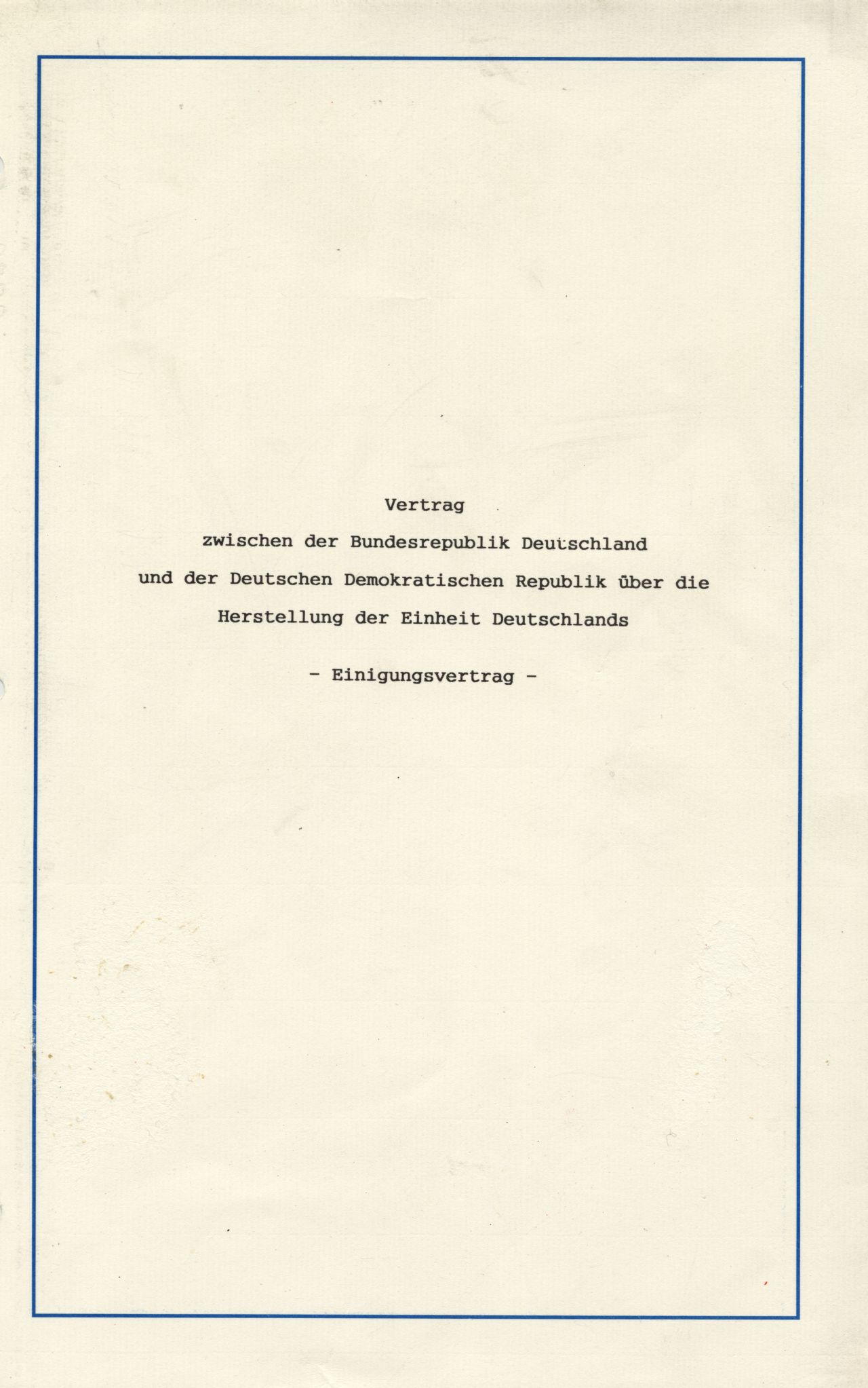 In einer dunkelblauen Mappe mit dem Bundesadler (Goldprägung) auf der Vorderseite befindet sich der Vertrag zwischen der Bundesrepublik Deutschland und der Deutschen Demokratischen Republik über die Herstellung der Einheit Deutschlands.